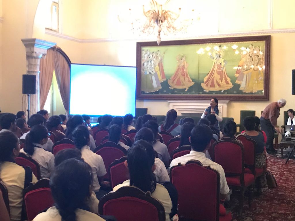 Children watching the short film on making of blue pottery process