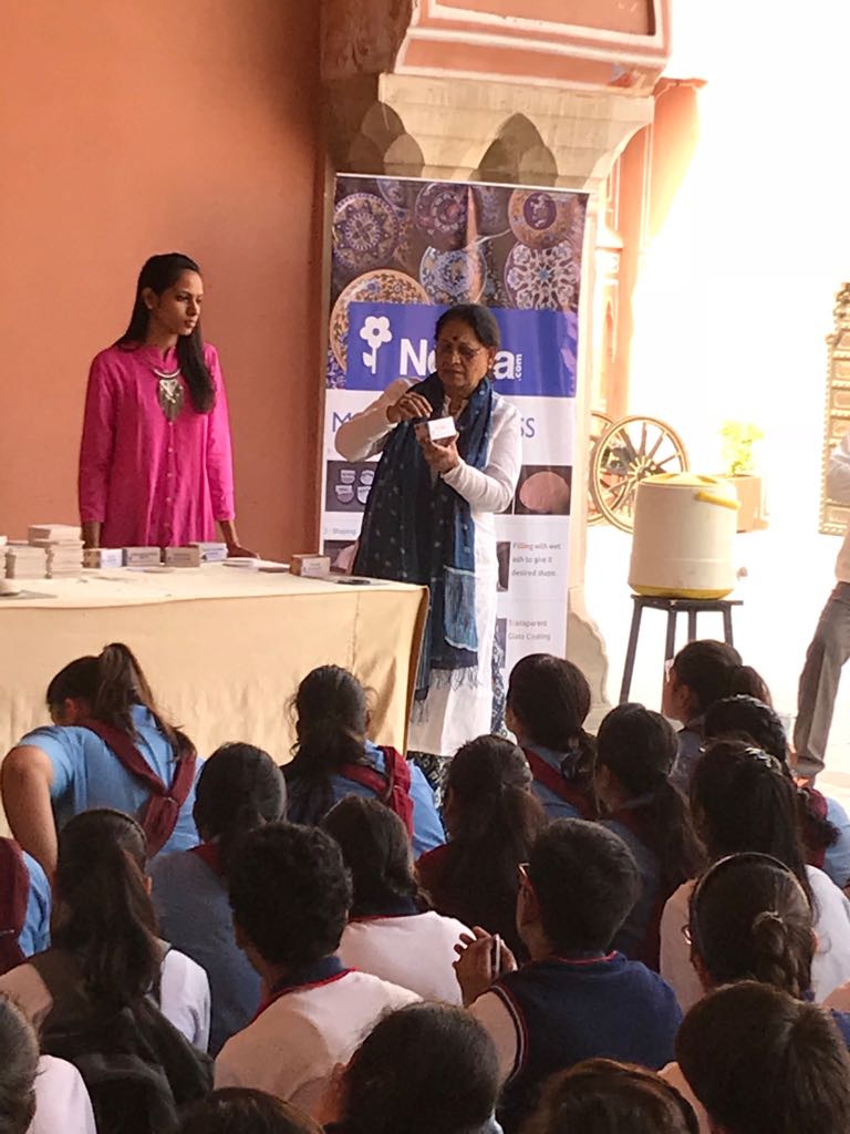 Ma'am making the children understand about blue pottery