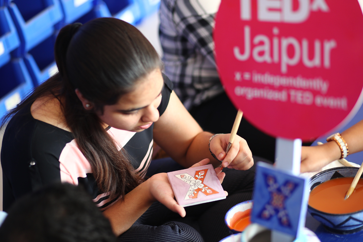 Student dedicately designing the tile